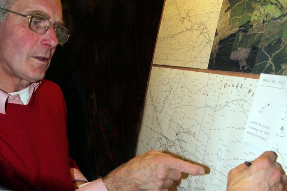 A person pointing at a map