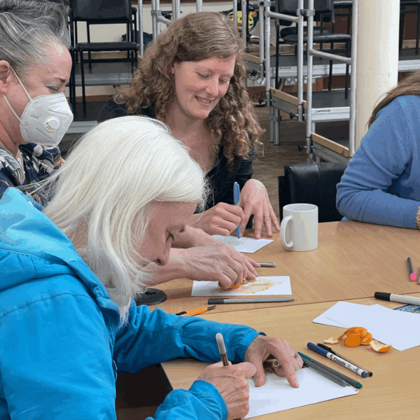Four people drawing and writing.