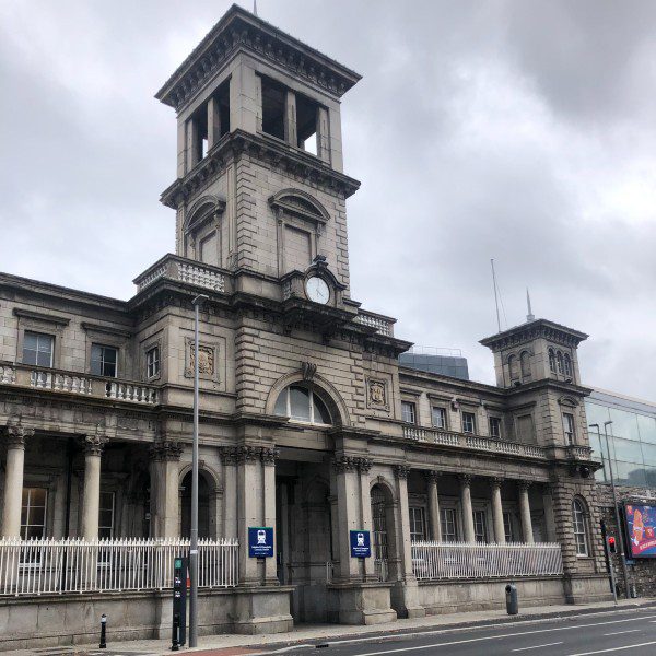 A grand-looking grey building with a clock tower.