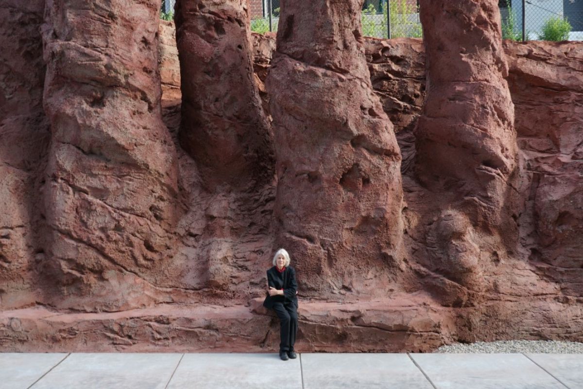 Artist Patricia Johanson sitting on the public artwork The Draw
