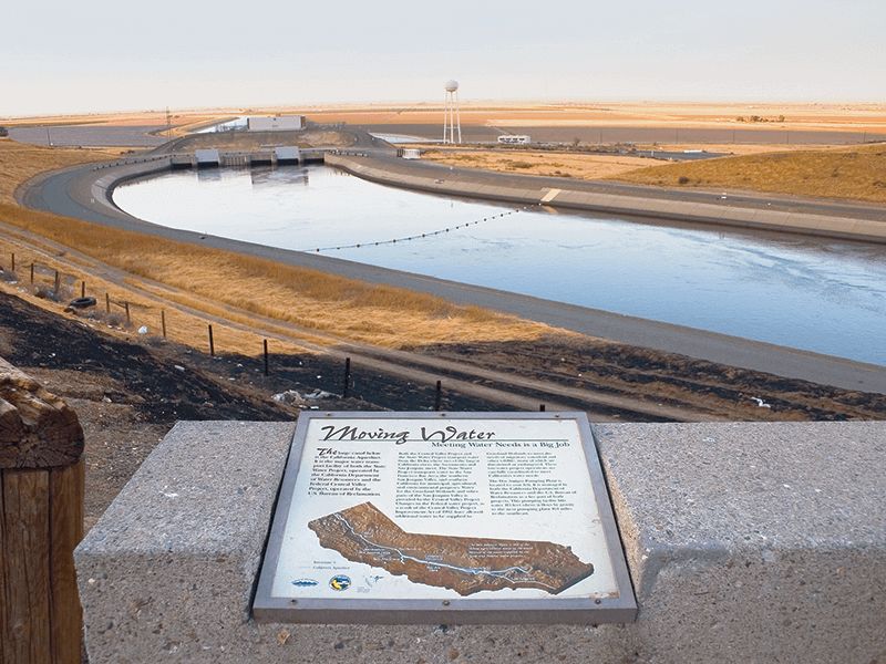 A landscape photo of a body of the California Aqueduct. In the foreground is a map with a description of the site.