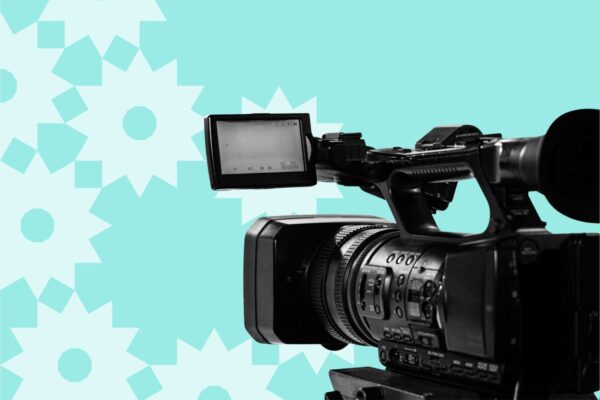 A movie camera on a patterned background