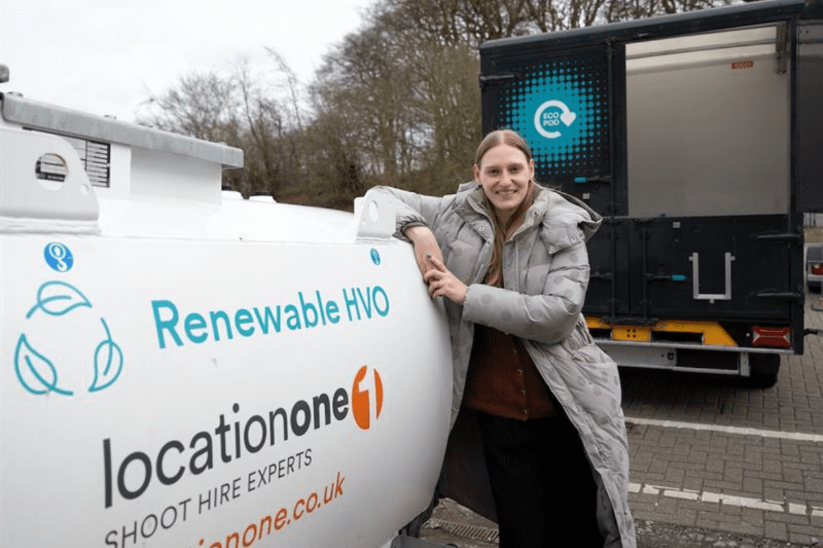 A person leaning against a renewable hydrotreated vegetable oil tank