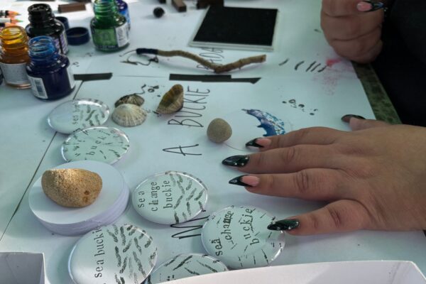 Close up of a person's hands making badges