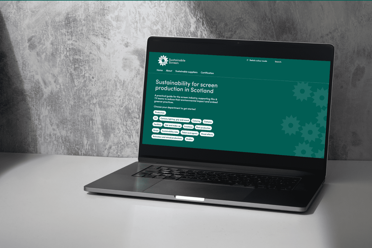 Black and white image of a laptop with the Sustainable Screen website on display